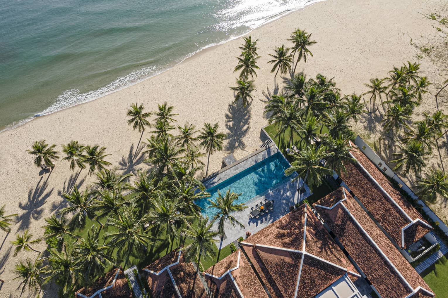 5 Bedroom Beachfront Pool Villa aerial shot with palm trees and ocean views