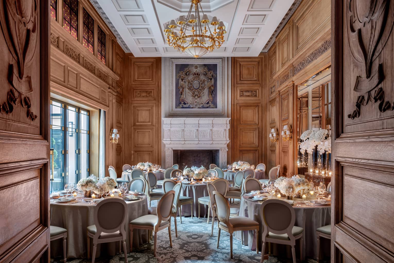 Salon Louis XIII room banquet, elegant carved wood doors, walls and ceiling, painting over mantle 