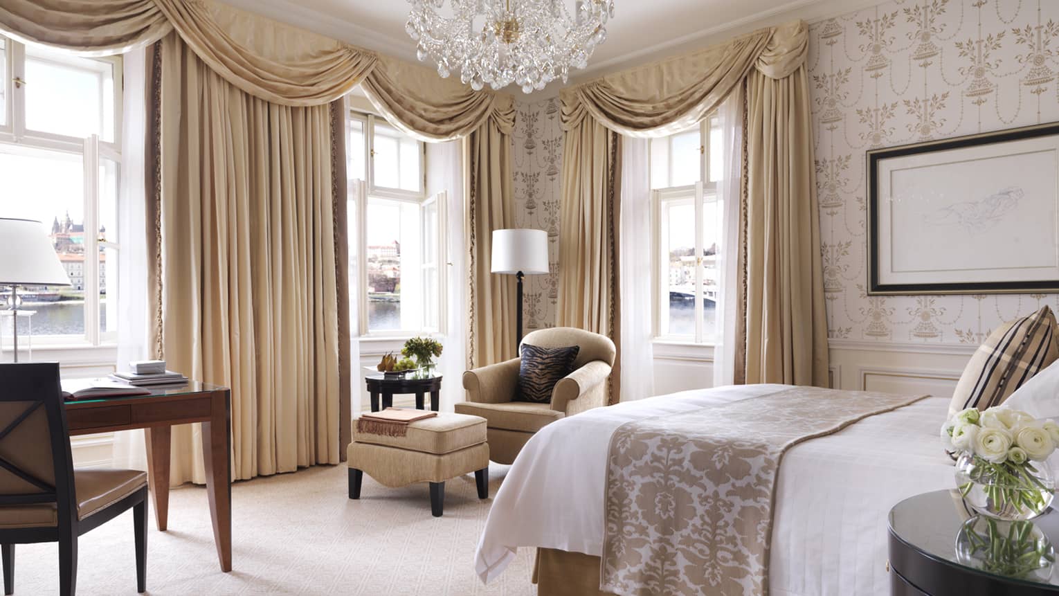 Premier Room bed, desk, chair, cream-and-gold Old European decor, long curtains, crystal chandelier