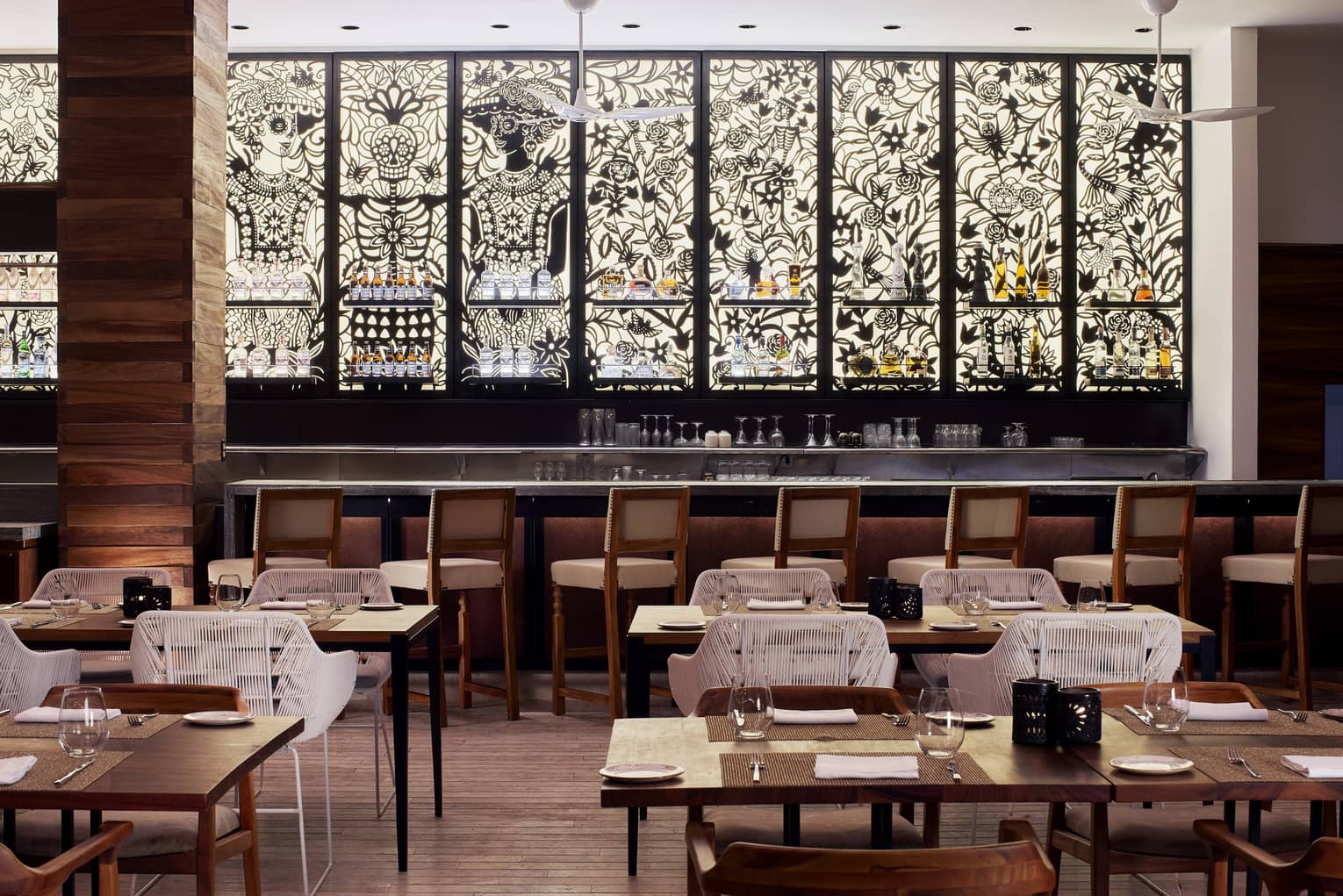 Black and white mosaic stain glass windows line the interior walls of Dos Catrinas