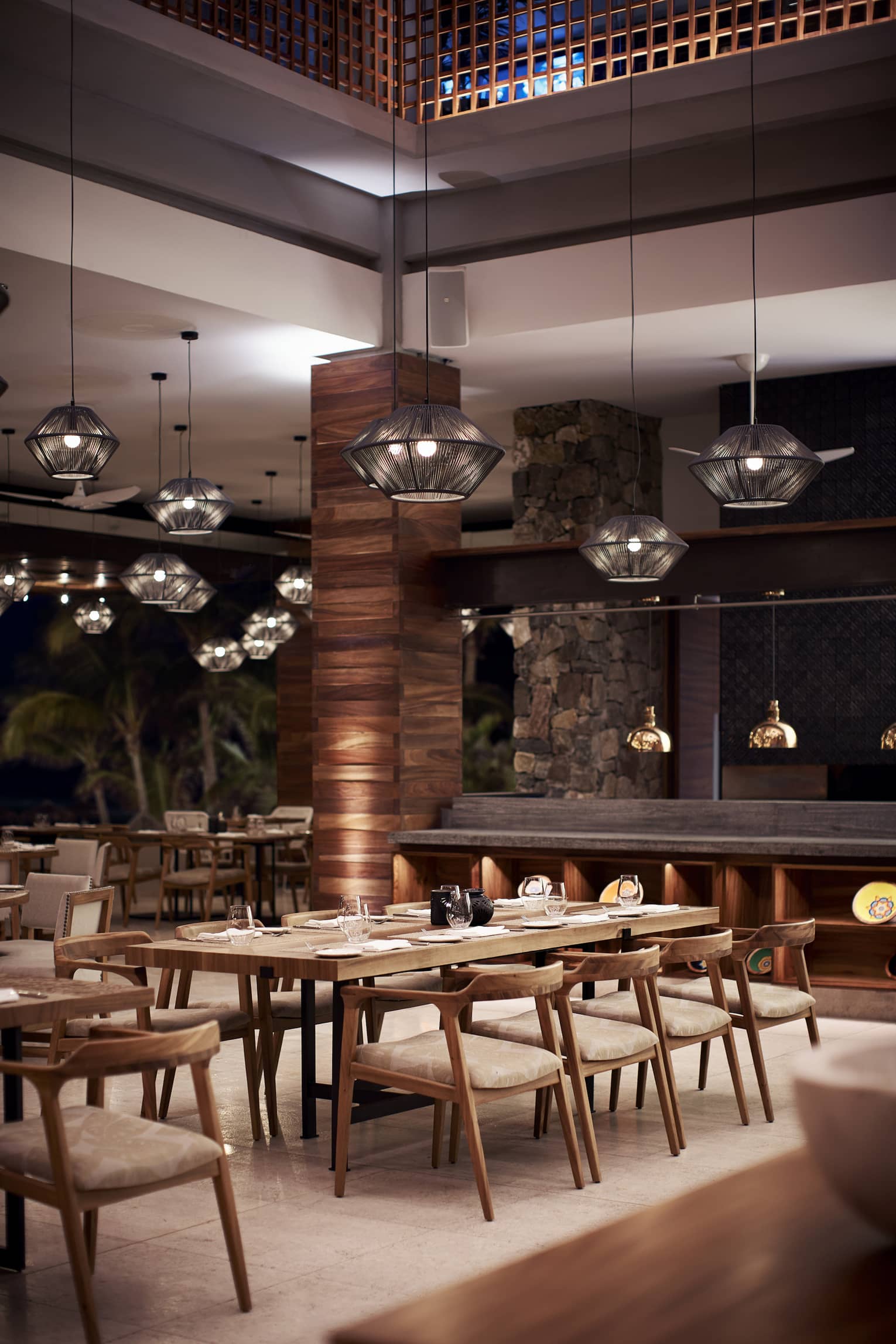 black basket lights hang above wooden tables with place settings