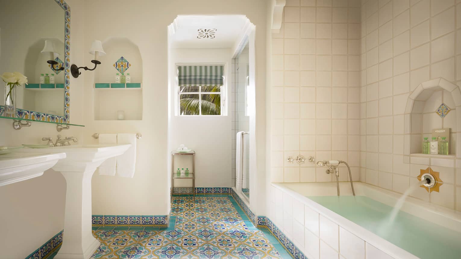 White tile bathroom, long tub, colourful Spanish Colonial-style tiles 