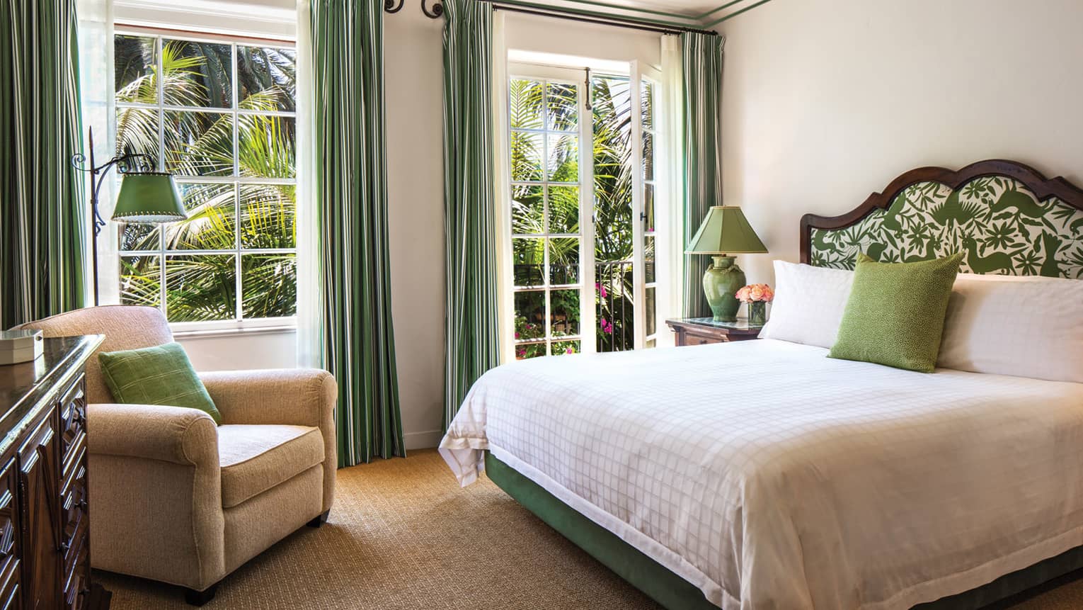 Santa Cruz Suite bedroom with green accent pillows, curtains and patterned headboard