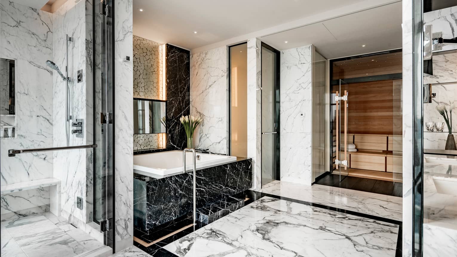 Presidential Suite full marble bathroom with white marble glass walk-in shower, black marble tub