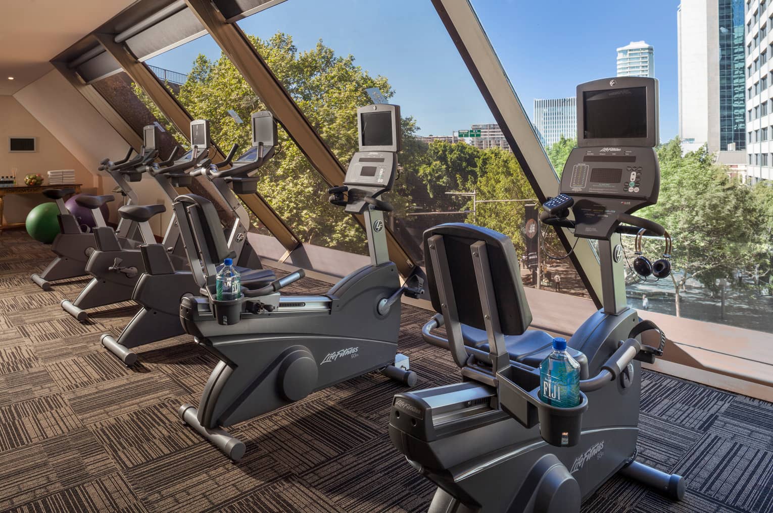 Cardio bikes, machines lined up by window in Fitness Centre