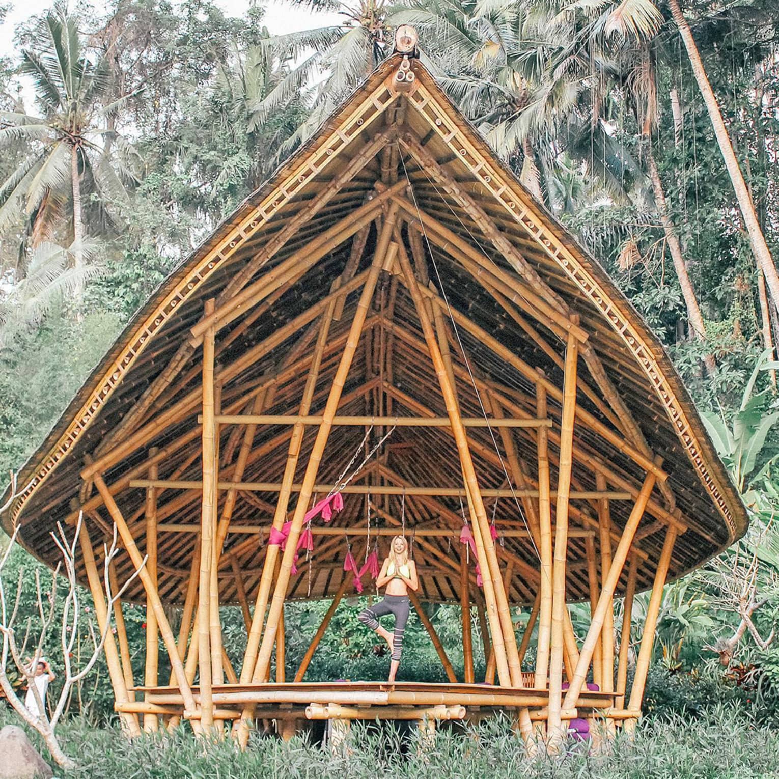 Woman in yoga pose on terrace in the jungle 