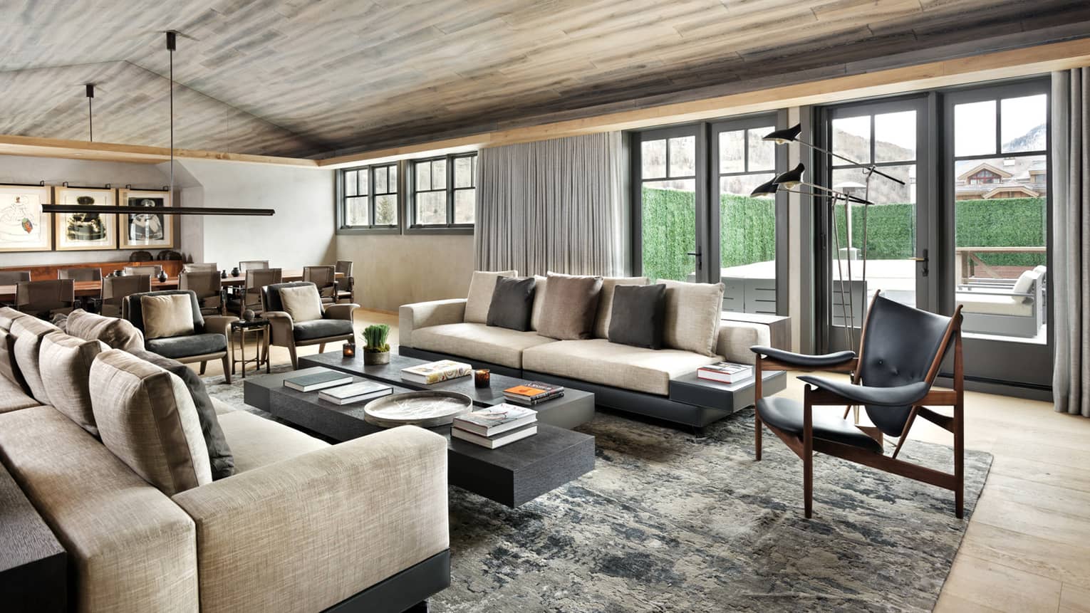 Long plush sofas, modern leather armchairs around large coffee table in bright living room