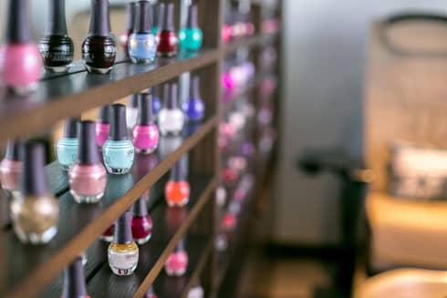 Close-up of colourful eco-friendly nail polish bottles on shelf at Driftwood Spa