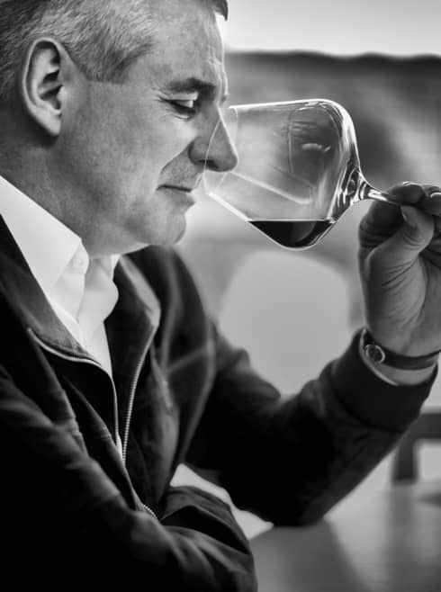 Black-and-white portrait photo of Restaurant Director Eric Beaumard with wine glass